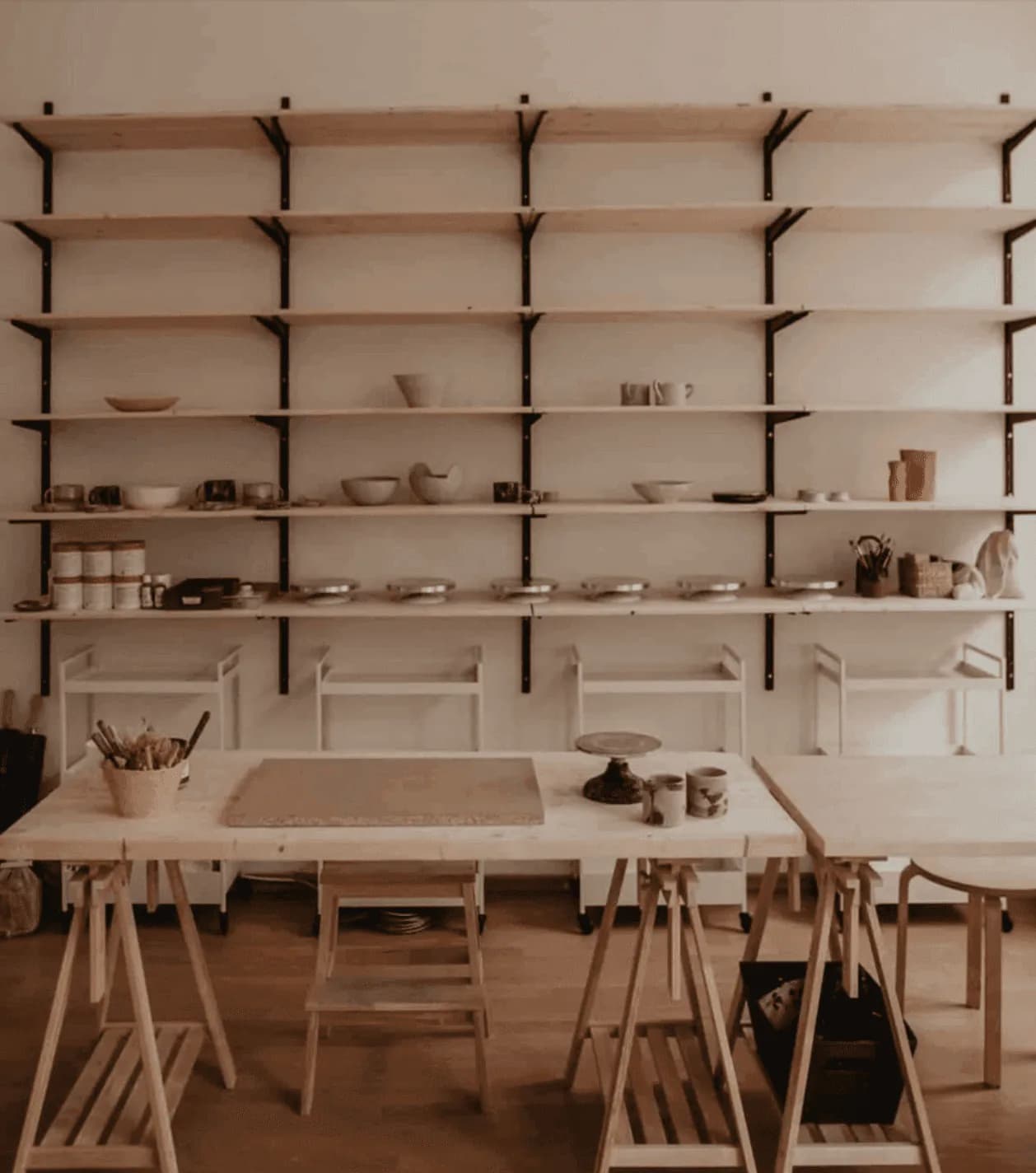 Pottery studio workspace with shelves and ceramic pieces